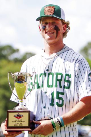 Lawson Wooten holds the 2024 GIAA-2A championship trophy after closing with two scoreless innings for the Gators in Macon. (LANCE MCCURLEY/Staff)