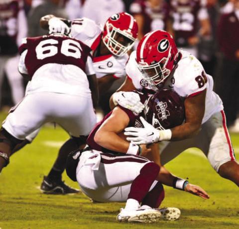 Georgia defensive linemen Jalen Carter (88) sacks Mississippi State quarterback Will Rogers during Saturday’s game in Starkville, Miss.
