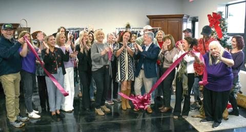Well-wishers cheer as the ribbon falls to officially open Second Chance Boutique at 939 Greensboro Rd., Eatonton. Proceeds from the upscale thrift store will benefit Circle of Love, a long-running domestic violence shelter in Greene County. IAN TOCHER/Staff