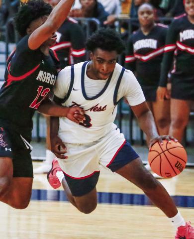 Putnam County senior guard Jmari Greene (3) drives the lane against a Morgan County defender in a win over the Dogs on Nov. 20. LANCE McCURLEY/Staff