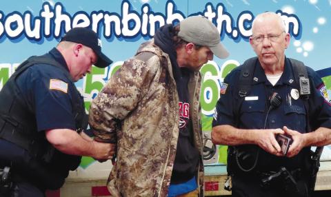 Eatonton Police Department officers handcuff David Emanuel Garcia, 39, of Macon.