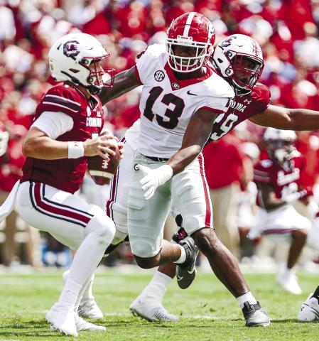 Georgia defensive lineman Mykel Williams (13) closes in on South Carolina quarterback Spencer Rattler ( ADAM WALSH/UGA Athletics 7) during Saturday’s game.