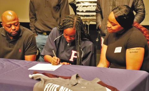 Robertson signs her letter of intent to play at Paine College. ARELLA CASH/Staff