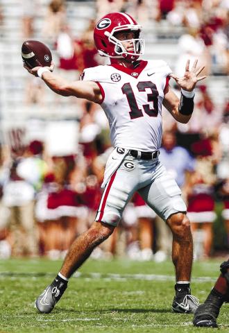Georgia quarterback Stetson Bennett (13) drops back for a pass during its SEC opener with South Carolina Saturday. Bennett led the team in both passing and rushing yards. ADAM WALSH/UGA Athletics