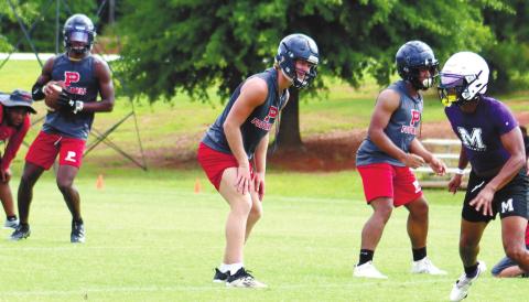 Jalon Kilgore takes the snap with Seth Boyer in protection. ARELLA CASH/Staff