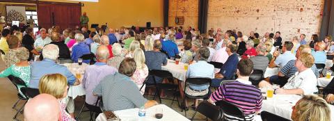 The name change to Neighbors Helping Neighbors was announced Tuesday night at a membership meeting held at Oconee Brewing Company. Some recipients spoke to the group about how the organization has helped improve their lives. MARK ENGEL/Staff