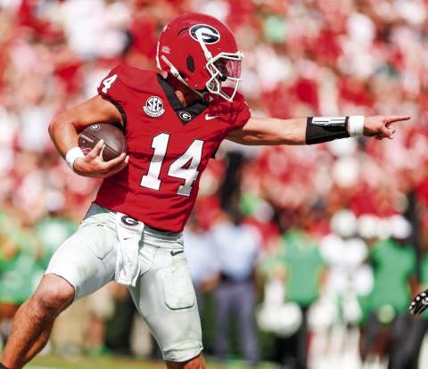Georgia quarterback Gunner Stockton (14) accounted for four touchdowns in the team’s 45-7 win over Marshall on Saturday. LANCE McCURLEY/Staff