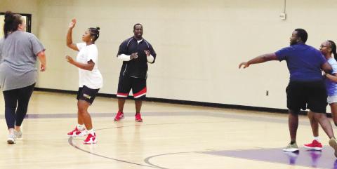Coach Arrington has Tytianna Little and Ti Davis run 2-on-2 practice with Assistant Coach Royal and David Levester.