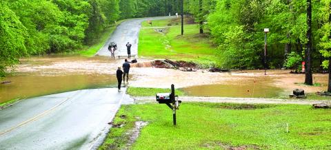 County officials assess West Riverbend Drive conditions Monday afternoon. CONTRIBUTED