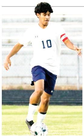 Putnam midfielder Angel Sanchez (10) dribbles past an Oglethorpe County defender in the regular season finale on April 15. The junior scored the go-ahead goal against Vidalia last Friday in overtime, helping the War Eagles advance to the second round of state playoffs. LANCE McCURLEY/Staff