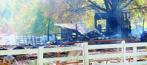 Smoldering ashes and rubble are all that’s left of a horse barn after a fire at Manley Arena last week. LYNN HOBBS/Staff