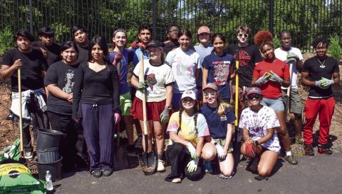 Hannah Erickson (center, kneeling) led an eager PCHS Beta Club crew in a major planting project to help beautify Jimmy Davis Park while eventually providing added privacy to nearby neighbors. IAN TOCHER/Staff