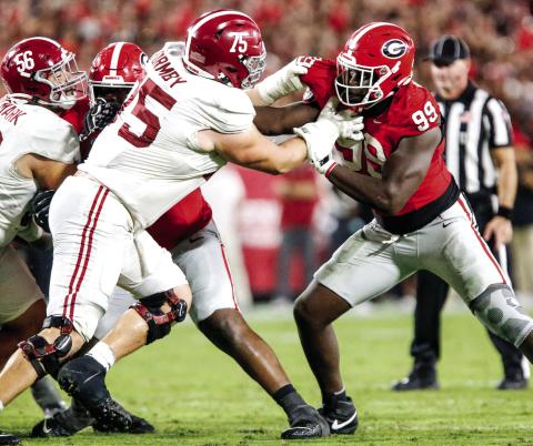 Georgia defensive lineman Joseph Jonah-Ajonye (99) tries to get around Alabama offensive lineman Wilkin Formby (75) and make a tackle in the backfield. LANCE McCURLEY/Staff