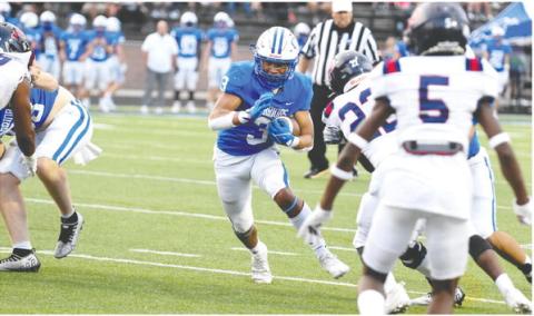 Oconee County running back Caiden Wood (3) runs through a hole in the Putnam County defense in Friday’s win. LANCE MCCURLEY/Staff