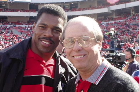 Two of the best-ever at their chosen crafts: Bulldogs’ football legend and 1982 Heisman Trophy winner Herschel Walker (left) with UGA’s legendary Sports Information and Communications Director Claude Felton on Dooley Field at Sanford Stadium in Athens. (Photo courtesy of UGA Athletics)