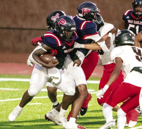 Putnam County running back Rashod Daniel (3) tries to run past Morgan County defenders in a game earlier this season. FILE PHOTO
