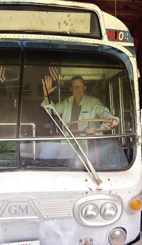 T.M. Brown sits in the driver seat of Fred and Kay Wallace’s bus that serves as the inspiration to the next installment in his Shiloh mystery series. CONTRIBUTED