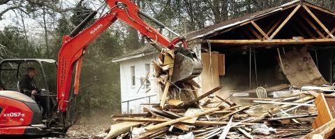 A demolition worker tears into Rooty Creek Primitive Baptist Church last week, readying it for a trip to a landfill. IAN TOCHER/Staff