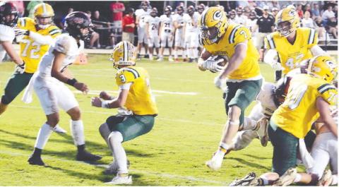 With Jackson Hewatt (3) providing cover, Evan Bennett (7) makes his way across the goal line for Gatewood's first touchdown last Friday night in a 17-8 win over Briarwood. IAN TOCHER/STAFF