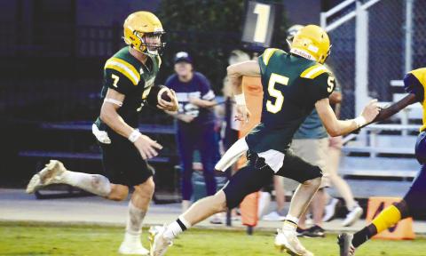 Fellow Gatewood seniors Evan Bennett (7) and Blake Callaway (5) each scored two touchdowns in the Gators’ 35-0 win over the Trinity Christian Crusaders Friday night in Dublin. IAN TOCHER/Staff