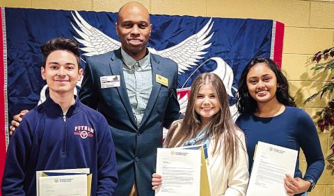 Georgia Tech’s Antwuan Holloway (center) visited Putnam County High School Dec. 5 to notify PCHS seniors (l-r) Carlos Jimenez, Carolyn Thomas, and Vidhi Raiyani, that they had each been accepted into the prestigious, downtown Atlantabased university through its highly competitive Early Action program. CONTRIBUTED