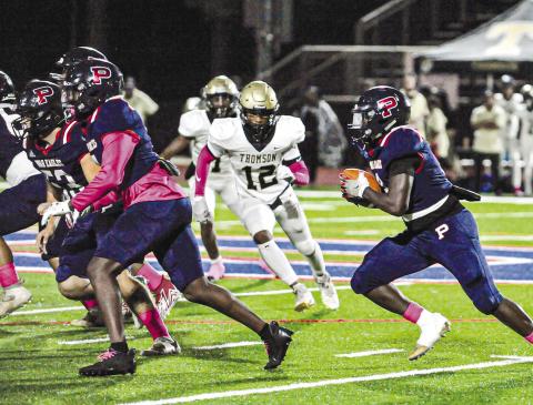 Rashod Daniel (3) carries the ball behind blockers in a game against Thomson on Oct. 20. CHARLES JORDAN/Staff