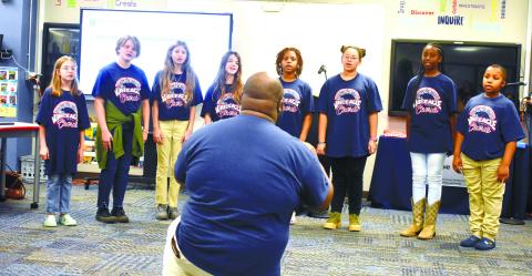 Chorus teacher Ontario Williams leads sixth grade chorus members in singing ‘Color of the Wind’ from the Disney movie Pocahontas.