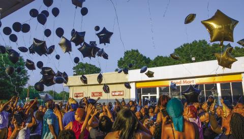 More than 100 people gathered to release memorial balloons last Friday night outside a Shell station in Eatonton where Frederick Scott Jr. was murdered June 4, in a broad-daylight shooting.