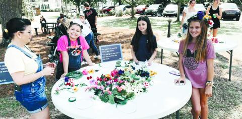 Attendees of last year’s spring event make flower crowns. CONTRIBUTED