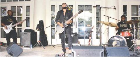 At least one happy couple outwaited the wet stuff to share a dance to the sounds of Cash’s Juke Joint, playing Saturday afternoon on the steps of The Plaza Arts Center in Eatonton.