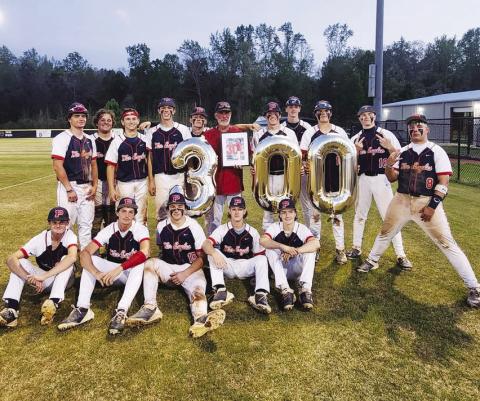 Following a 7-4 decision over Jasper County on March 31, War Eagles head baseball coach Stephen Phillips (in red) shared his accomplishment of reaching 300 career wins with his current team and family members. CONTRIBUTED
