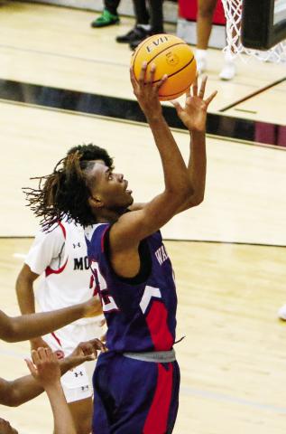 Putnam County’s Shamar McClendon soars over a Morgan County defender for an easy layup. LANCE McCURLEY/Staff