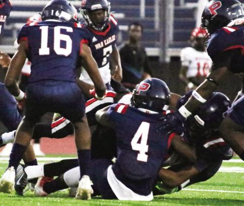 Several Putnam County defenders, including Braxston Mays (4) and Kaleb Lawrence, bring down a McNair ball carrier in last Friday’s win. LANCE McCURLEY/Staff