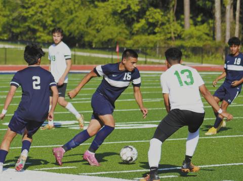 Emmanuel Meraz (12) dribbles through Rutland defenders. ARELLA CASH/Staff