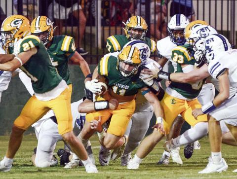 Gatewood junior Mason Sinclair (11, center) fights for every inch of turf Friday night in a disappointing 28-12 loss to the visiting Trinity Christian Crusaders. IAN TOCHER/Staff