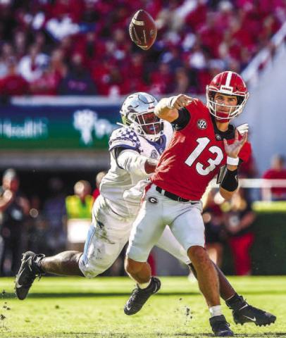 Quarterback Stetson Bennett (13) went 14-20 passing in 2021 against Kentucky for 250 yards and three touchdowns with no interceptions for an average of 12.5 yards per play. He also rushed three times for 22 yards. TONY WALSH/UGA Athletics