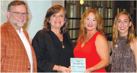 L-R: Chuck Haley, president of The Peoples Bank, Linda Moore and Amy McElhaney, both of Farmers &amp; Merchants Bank, and Chamber of Commerce President and CEO Maggie Milner celebrate Farmers &amp; Merchants Bank being named 2022 Business of the Year for Eatonton-Putnam County. IAN TOCHER/Staff