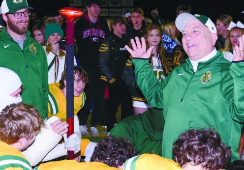 Gatewood head coach Jeff Ratliff (right) was all smiles after his Gators won back the “Whoopin’ Stick,” held by star player Evan Bennett, who had on a cast covering most of his right forearm in a return to play after missing several games due to an injury suffered earlier this season. IAN TOCHER/Staff
