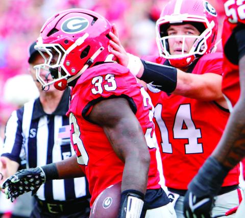 Georgia running back Chauncey Bowens (33) celebrates with teammates after scoring a touchdown against Austin Peay on Saturday. LANCE McCURLEY/Staff