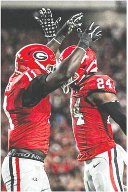 Sophomore linebacker Jalon Walker (11) and defensive back Malaki Starks celebrate during the win o ver UAB at Sanford Stadium. CHARLES JORDAN/Contributed