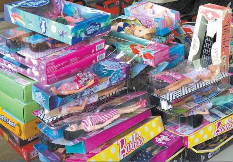 Barbie and other dolls are stacked ready for delivery in last year’s Fireman Santa project. Each year, the program helps Santa get toys to needy children for Christmas. FILE PHOTO