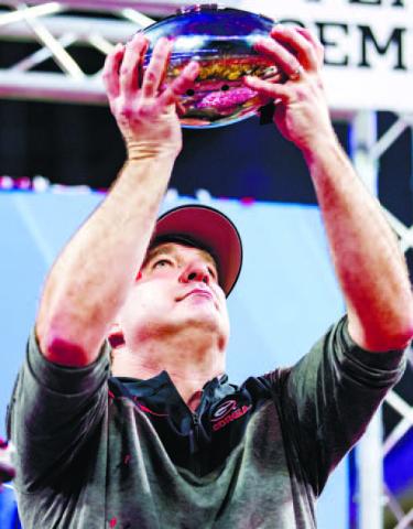 Georgia head football coach Kirby Smart displays the Peach Bowl trophy after the Bulldogs secured their trip to Los Angeles to face TCU. TONY WALSH/UGA Athletics