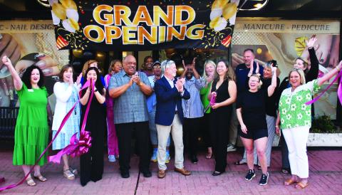 Eatonton Mayor John Reid (grey shirt) and his wife, Janie, joined Eatonton-Putnam Chamber of Commerce President Robbie King (center) in welcoming business owner Jennifer Nguyen (with scissors) to a ribbon-cutting ceremony for Sassy Nails, a full-service hand-and-foot spa now open at 117 S. Jefferson Ave. in downtown Eatonton. IAN TOCHER/Staff