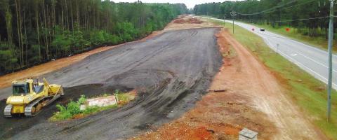 Georgia Dept. of Transportation contractor workers are making preparations to complete the US Hwy. 441 widening project in Putnam County. MARK ENGEL/Staff