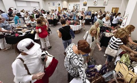 Women dominated the crowd at Upscale Resale, where donated, gently used, high-end pieces of jewelry, purses and carryalls, some clothing, and even a collection of fine jewelry was available for purchase to support local food pantries. IAN TOCHER/Staff