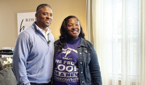 NFL star Warrick Dunn with I’Keirra in the living room of her brand-new home. EMME CLAUSE/Staff