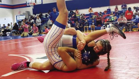 Putnam County’s Lily Armistead tries to pin her opponent during a match earlier this season. CONTRIBUTED