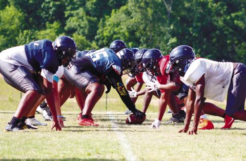 Putnam County’s first-team offensive and defensive lines get set for a live-action rep at Monday’s spring practice. LANCE McCURLEY/Staff