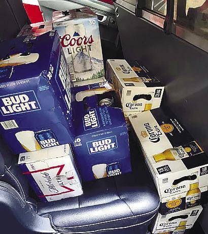 Cases of stolen beer are stacked in the back seat of the Camry involved in a police pursuit. The brews were returned safely to the grocery store. CONTRIBUTED