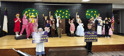 Dressed as Lemonade storybook characters, young Gatewood actors hold up lemons while others display signs reminding everyone: “When life gives you lemons, make lemonade!” EMME CLAUSE/Staff